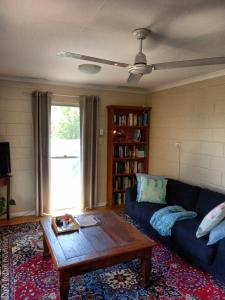 a living room with a couch and a coffee table at J & Ella's Holiday House - 2 Bedroom Stays in Cooktown
