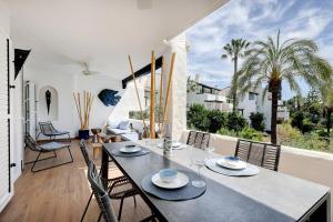 a dining room with a table and chairs at Luxurious apartment in Puente Romano, Marbella (Golden Mile) in Marbella