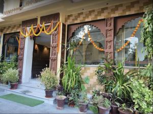 a house with potted plants in front of it at Hotel Rani Palace at Lake Fatehsagar in Udaipur