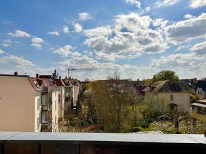 a view of a city from the roof of a building at Geschmackvolle Ferienwohnung in Markkleeberg in Markkleeberg