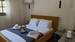 a bed with towels and a tray of food on it at Villa Armonia in Kalamata