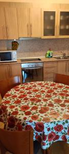 a kitchen with a table with roses on it at Comfort Zamenhof in Varna City