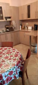 a kitchen with a table with a flower pattern on it at Comfort Zamenhof in Varna City