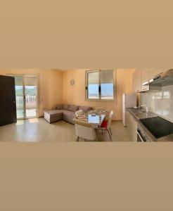 a kitchen and living room with a couch and a table at Apartament Real Vlore in Vlorë