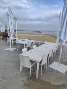 a group of tables and umbrellas on the beach at Lovin Puglia Vacation in Bari