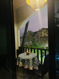 a dining room table with a view of a balcony at MILD ROOM SEA VIEW ROOM FOR RENT in Phi Phi Don