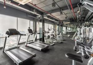 een fitnessruimte met diverse loopbanden en cardio-apparatuur bij The tree bang po station in Bang Su