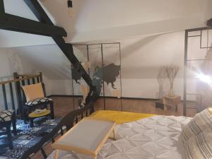 Habitación con cama, mesa y sillas. en petite maison cosy en duplex, en Éguelshardt