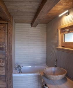 a bathroom with a large sink and a tub at Chalet neuf La Perle du Perron in Cordon