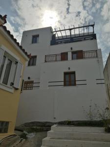 a white building with a balcony on top of it at Sofirene II in Batsi