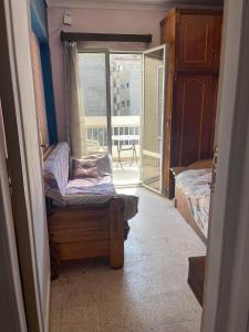a room with a chair and a window with a view at شقه مفروشه سوبر لوكس بميامى الاسكندريه in Alexandria