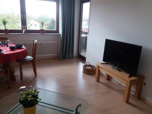 a living room with a flat screen tv on a table at Ferienwohnung im Pfaffenwinkel in Weilheim in Oberbayern