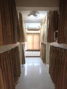 a room with brown curtains and a white tile floor at Chiangmai Delight Hostel in Chiang Mai