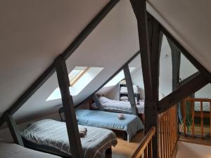 a attic room with two twin beds in it at L'appart Audomarois in Saint-Omer