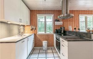 a kitchen with white cabinets and a sink at 3 Bedroom Gorgeous Home In Aakirkeby in Vester Sømarken