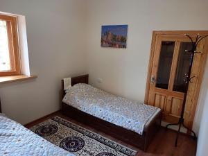 a bedroom with two beds and a door at Rassom Hostel in Samarkand