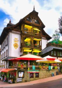 a large building with umbrellas in front of it at Hotel Pfaff in Triberg