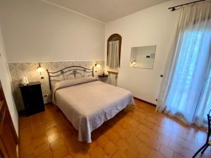 a bedroom with a large bed and a window at Casale del fattore in Cesena