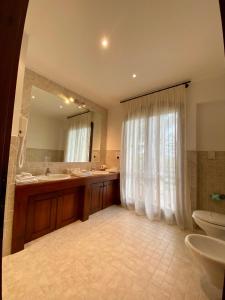 a bathroom with a sink and a toilet and a mirror at Casale del fattore in Cesena +42 photos