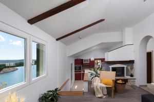 a living room with white walls and a large window at Green House in Novigrad Dalmatia