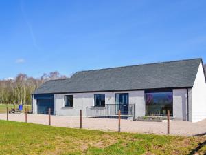 a white building with a black roof at Lady Jane Cottage in Fettercairn