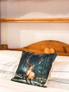 a painting of a deer on a bed at Green Park Studio Courmayeur in Courmayeur