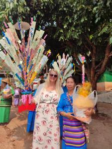 two women standing next to each other with a fan at Topp paiway hostel in Pai
