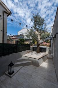 a tree sitting on top of a patio at Studio Apartment Mare with private garden and jacuzzi in Vinkuran