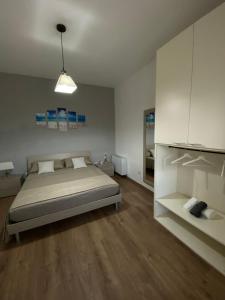 a bedroom with a bed and white cabinets at Cottage Cilento B&B in Trentinara