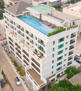 an overhead view of a white building with a swimming pool at GM Residence in Bangkok