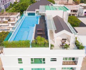 an aerial view of a building with a swimming pool at GM Residence in Bangkok