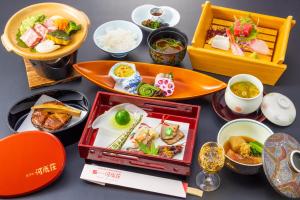 a table topped with plates of food and bowls of food at Hakone Yumoto Onsen Hotel Kajikaso in Hakone