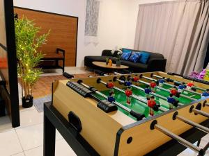a living room with a table with a large pool table at Ssrhomestay/S2/Corner lot/15pax in Seremban