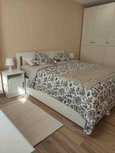 a bedroom with a black and white bed and a night stand at Tu piso en el centro in Santander