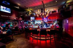 a bar with people sitting at tables in a restaurant at Boutique Thomas בוטיק תומאס in Haifa