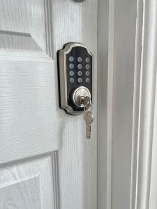a doorhandle with a cell phone on a door at Burleigh House - 3 Bed House in Leicester