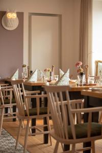 a dining room with a long table and chairs at Buchnas Landhotel Saarschleife in Mettlach +28 photos