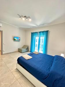 a bedroom with a blue bed and a window at Apartment NAPOLI MARADONA in Naples