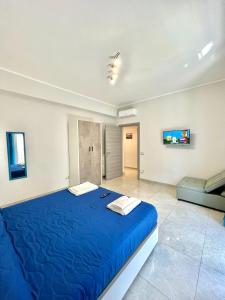 a large blue bed in a room with a couch at Apartment NAPOLI MARADONA in Naples