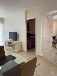 a living room with a tv and a bedroom at Apartamento en La Calma in Playas de Orihuela