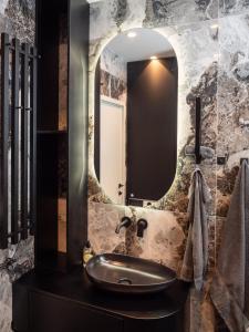 bagno con lavandino e specchio di Residence Republic Square- Top Location a Belgrado