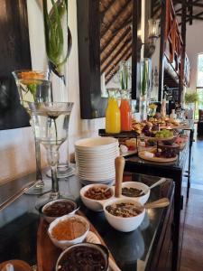 a buffet line with plates and bowls of food at Karongwe Portfolio - Kuname Lodge in Hoedspruit