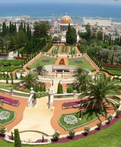 a view of a park with a building and trees at Boutique Thomas בוטיק תומאס in Haifa