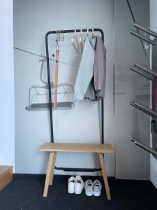 a walk in closet with a bench and shoes at hus9 in Mittelberg