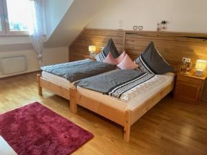 a bedroom with a large bed with a wooden headboard at Gästehaus Schneider in Eppishausen