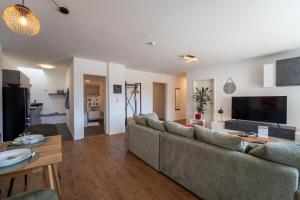 a living room with a couch and a table at J & K Apartments Kelheim in Kelheim