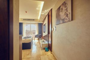A bed or beds in a room at Grand Hotel Port Said