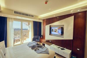 a hotel room with a bed and a window at Grand Hotel Port Said in Port Said