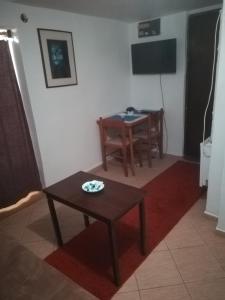 a living room with a table and a television at E & V free wi fi in Podgorica