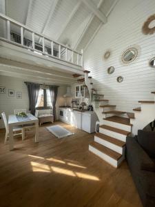 a living room with stairs and a table and a kitchen at Egeos Lake House in Sakarya